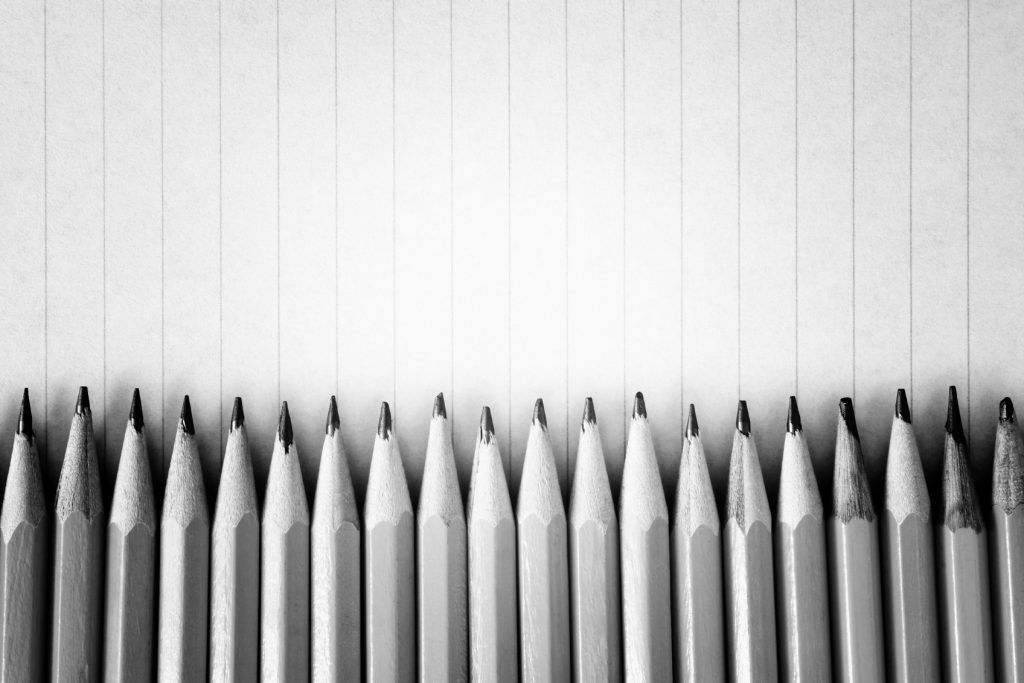 Sharpened pencils on a lined paper background