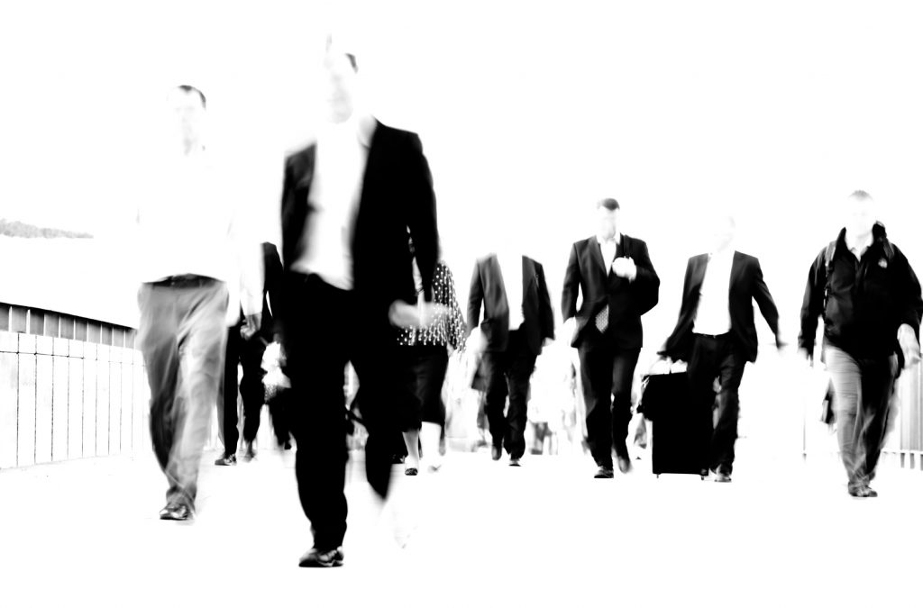 Businessmen walking across a bridge