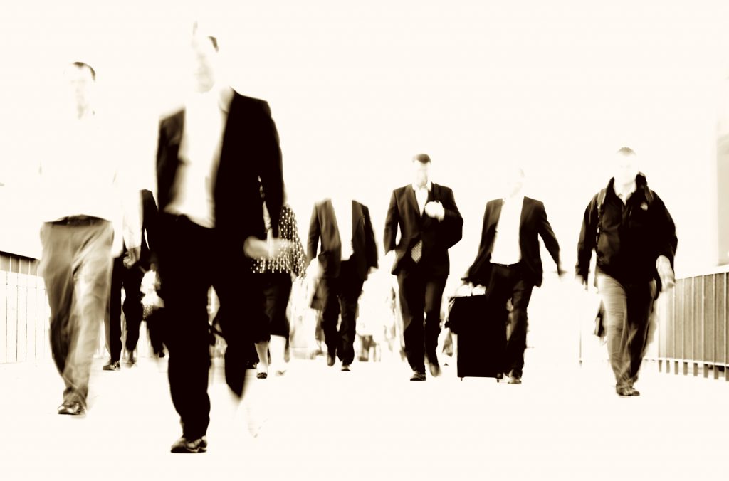 Businessmen walking across a bridge