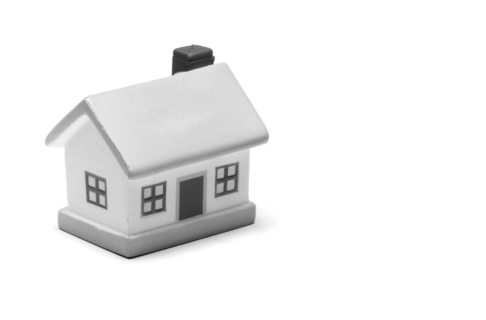 Miniature toy house on plain white background