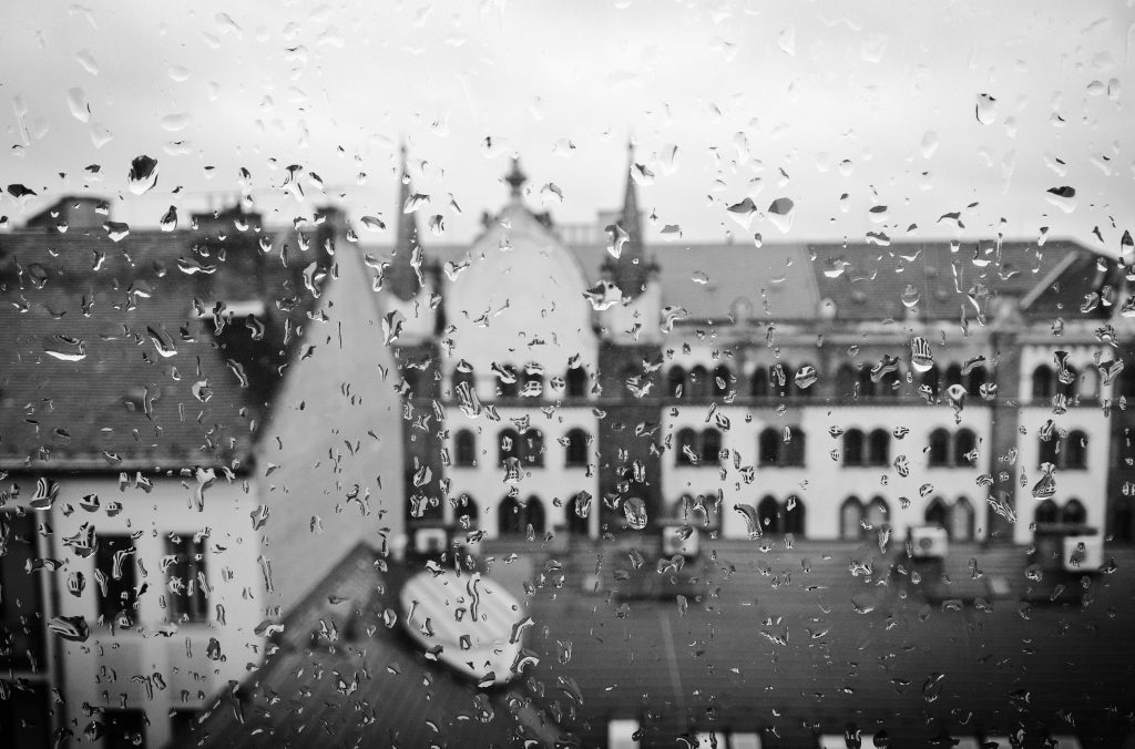 Rainy window looking out over city buildings