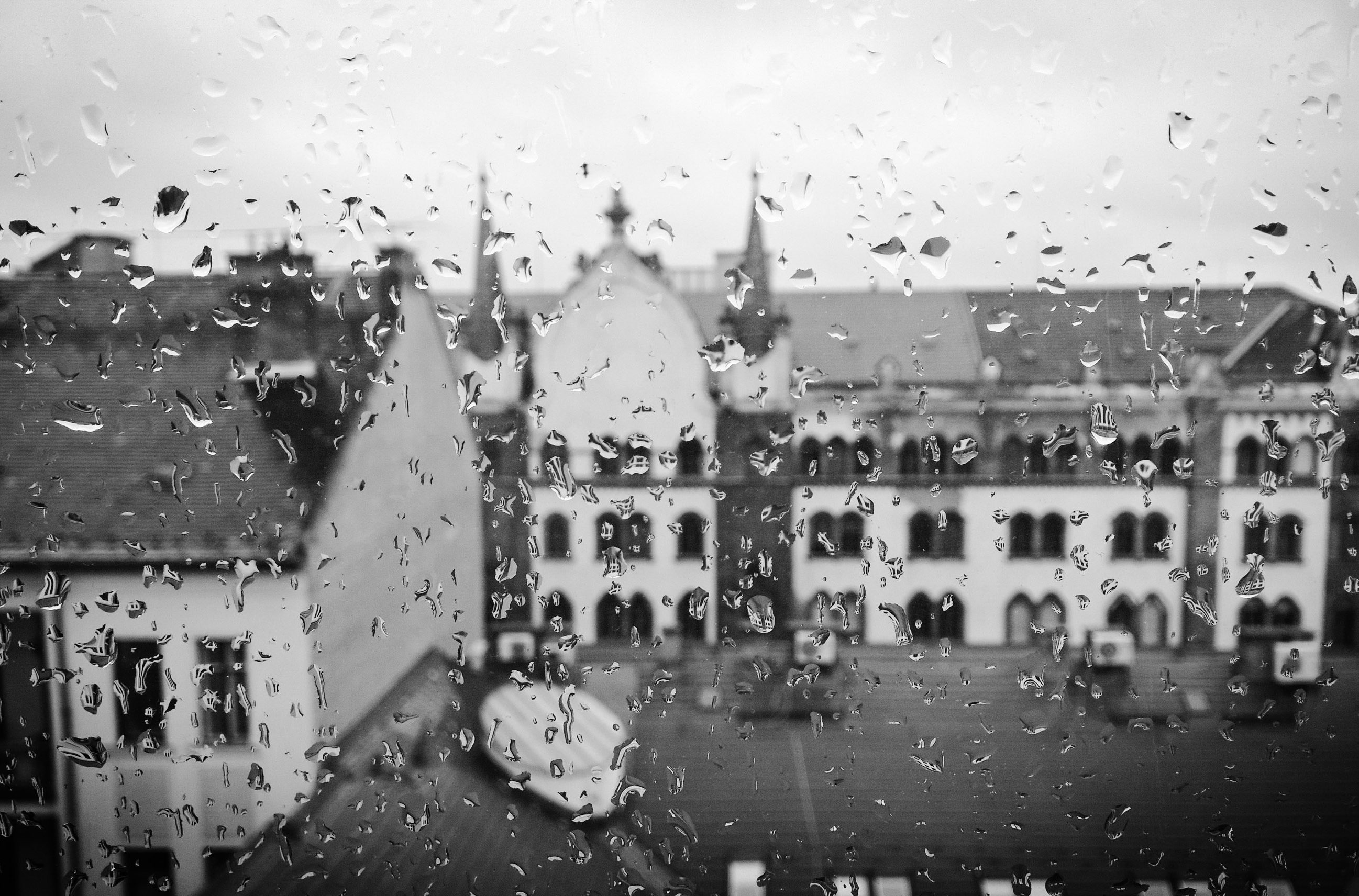 Rainy window looking out over city buildings