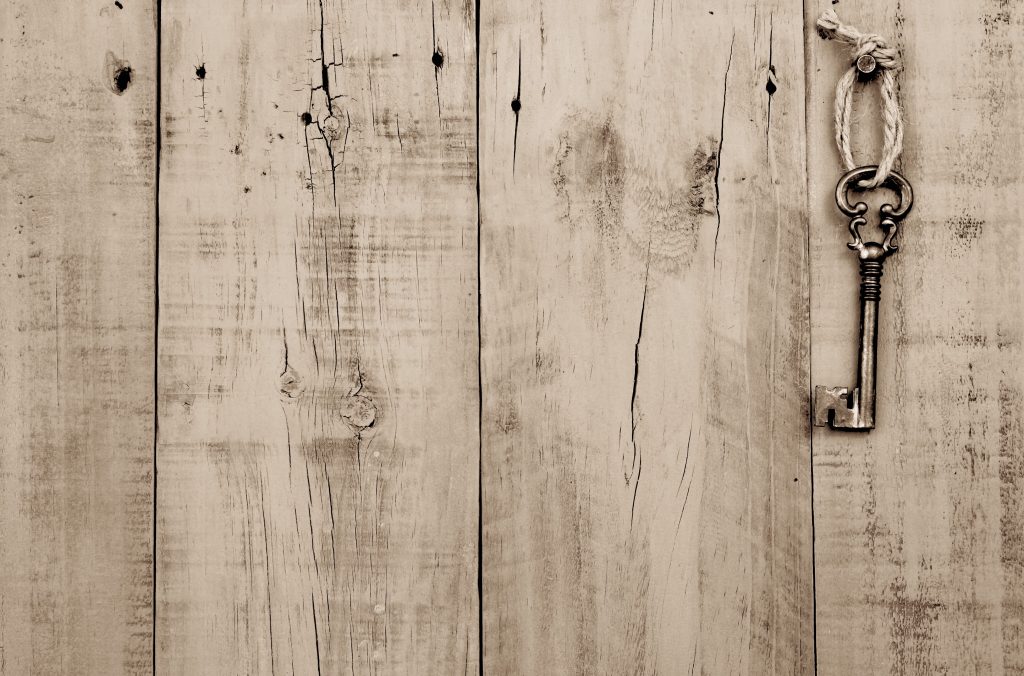 Skeleton key hanging on wooden door