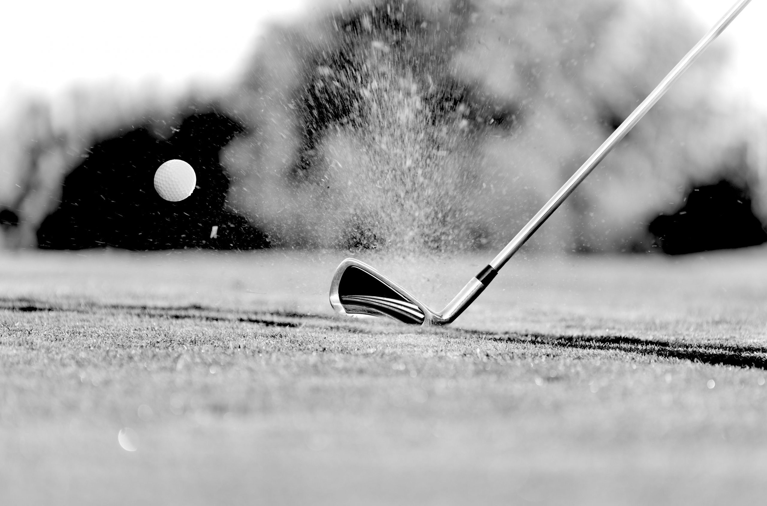 Close-up of golf ball with club during sunset